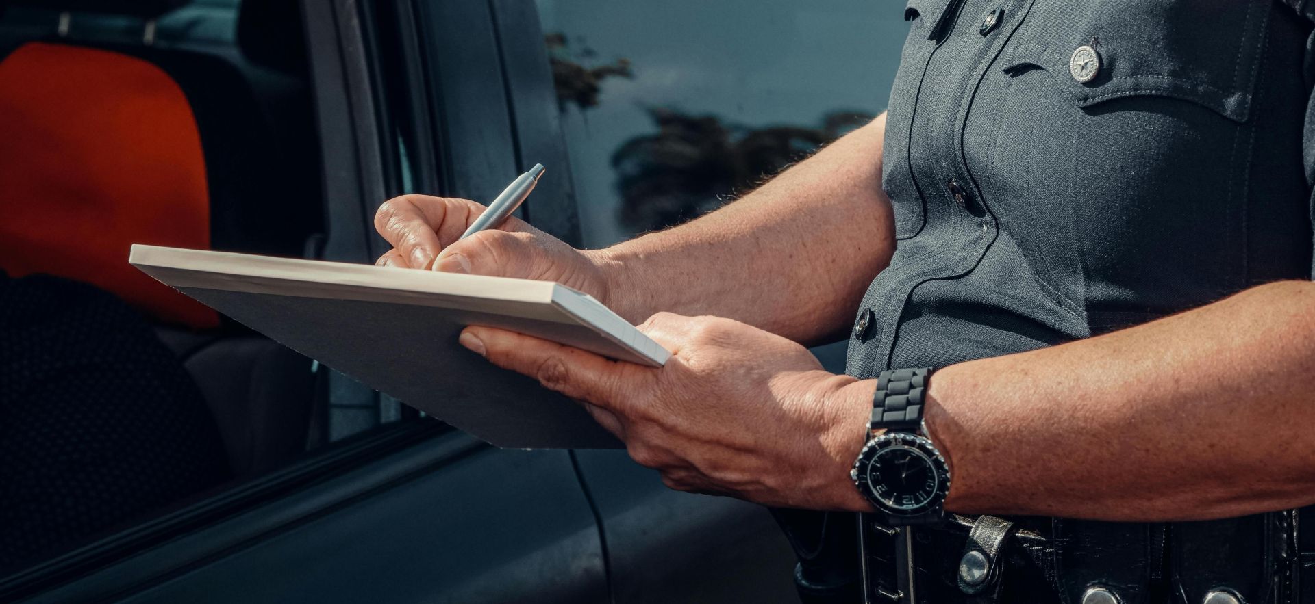 Police Officer Writing on a Notebook